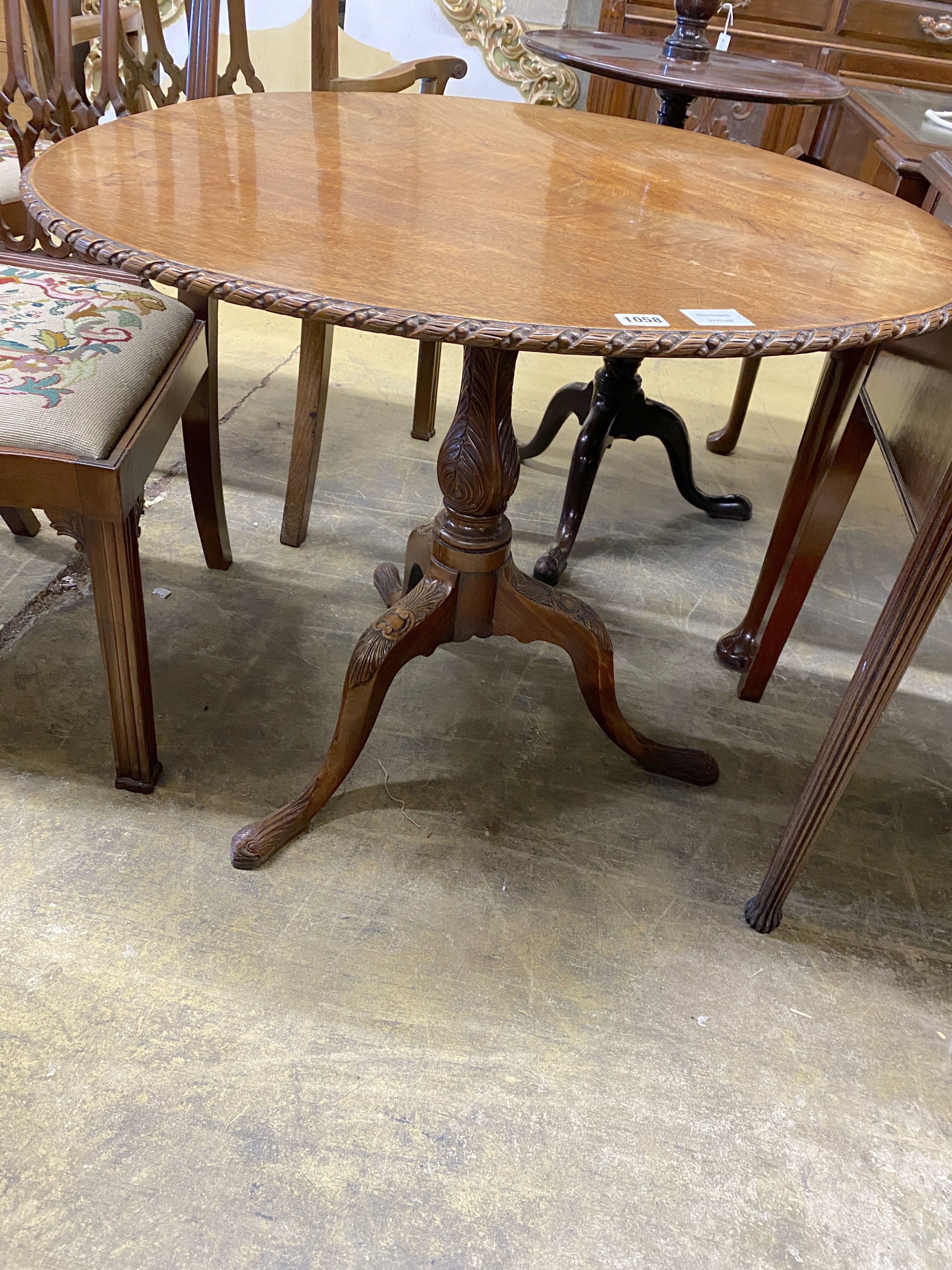 A George III carved circular mahogany tilt top tea table, diameter 88cm, height 71cm